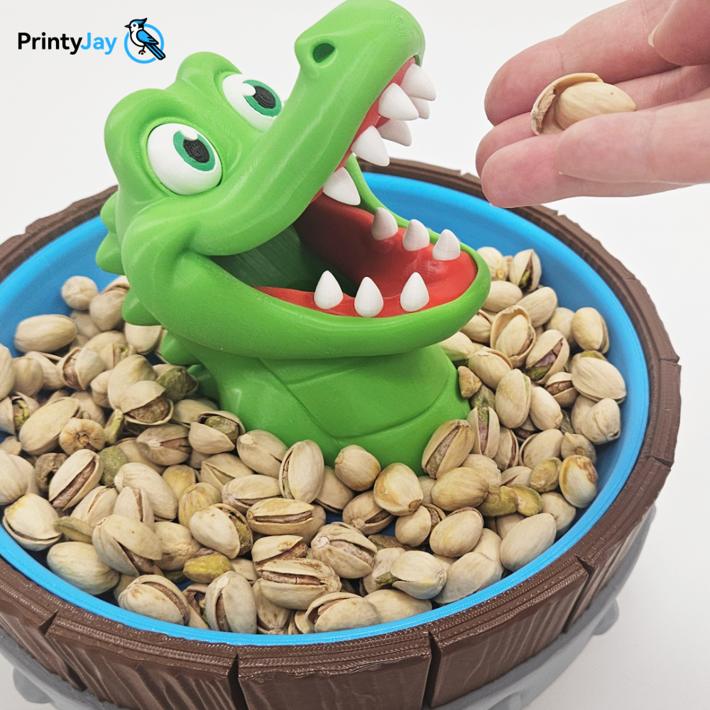 Green crocodile snack bowl 3D print holding pistachios - PrintyJay